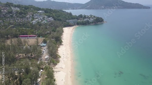Aerial shot of surin beach of phuket thailand with beautiful andaman sea and kamala beach and mountains on the background photo