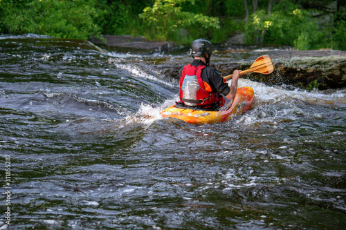 Fototapeta Naklejka Na Ścianę i Meble -  man kayaking in river