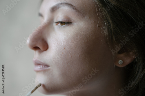 Wallpaper Mural Woman portrait during morning makeup. Concealer smear on face skin. Makeup brush Torontodigital.ca