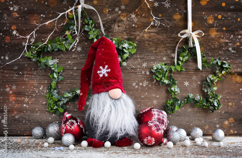 Photography Christmas composition with gnome and festive decorations on wooden background