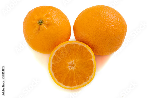 Three oranges isolated on a white background. Fresh citrus fruits.