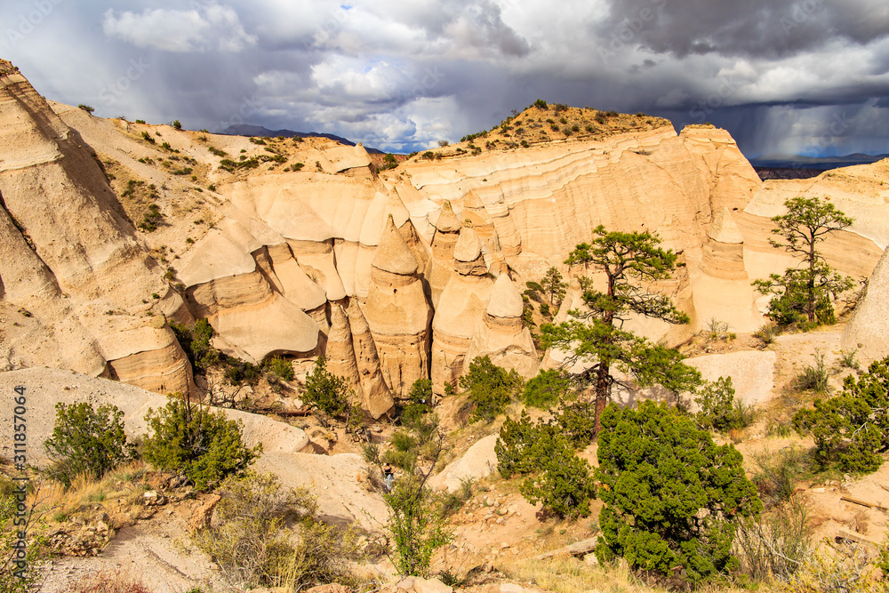 Fototapeta premium Landscape of rock formations against dark stormy sky in Kasha-Katuwe Tent Rocks National Monument in New Mexico, USA