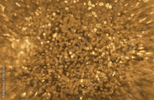 shiny festive blurred golden background with sparkles closeup