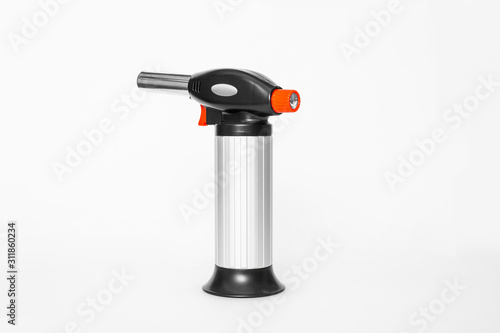 Culinary butane aluminum torch against a white background. gas burner for creme brulee isolated