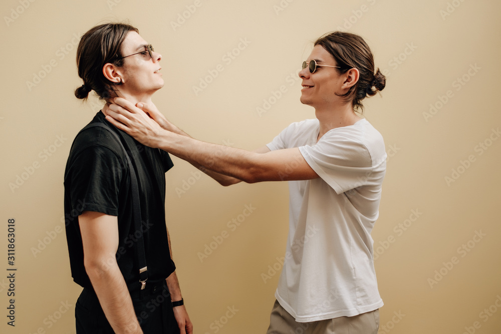 Close Up Portrait of Two Stylish Twins Brothers Dressed in Black and White T-shirts