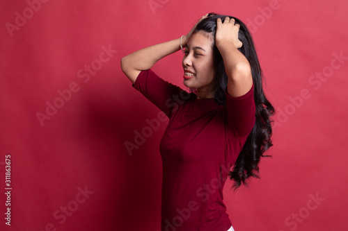 Stressed young Asian businesswoman scream out.