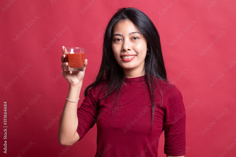 Young Asian woman drink tomato juice. Young Asian woman drink tomato juice.