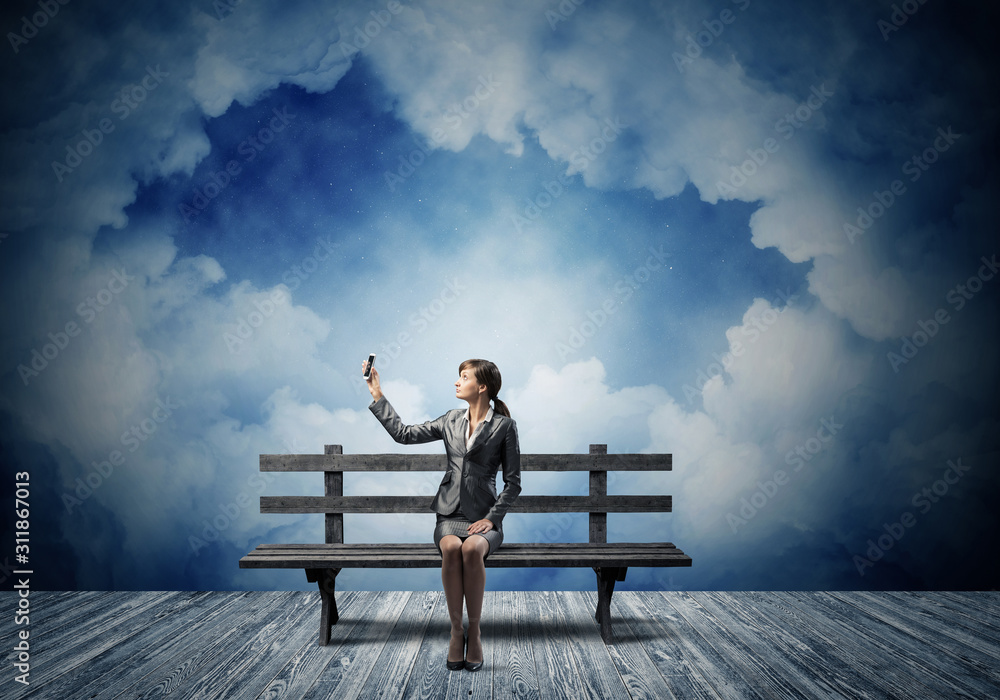 Young woman in business suit holding smartphone Young woman in business suit holding smartphone