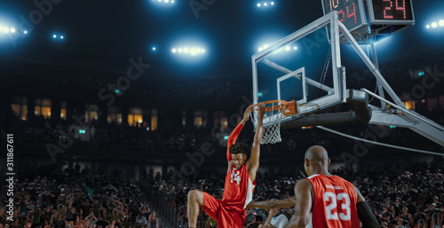 Basketball players on big professional arena during the game. Tense moment of the game. Celebration © haizon