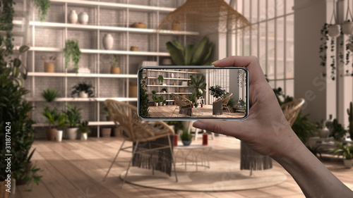 Hand holding smart phone, AR application, simulate furniture and interior design product in real home, architect designer concept background, winter garden, lounge interior design