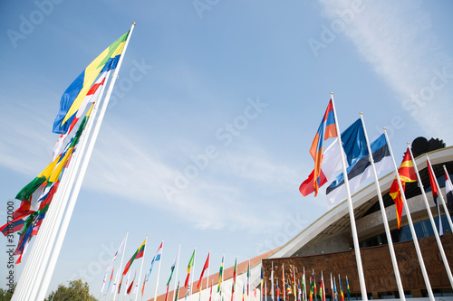 Flags of different countries against the sky