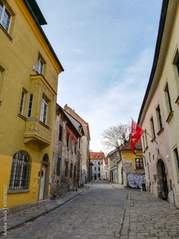 A beautiful typical paved street in Bratislava's Old Town district. June 2019, Slovakia. Sunny day in the capital. Interesting architecture and building facades.