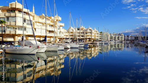 malerischer Hafen mit Spiegelung von Fuengirola in Spanien an der Costa del Sol im sonnigem Morgenlicht photo