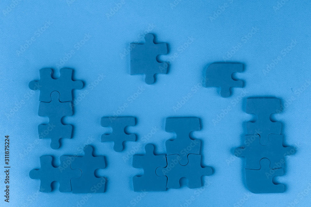 Puzzle pieces on classic blue background, top view Puzzle pieces on classic blue background, top view