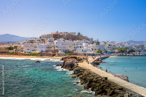 Chora of Naxos island as seen from the famous landmark the Portara with the natural stone walkway towards the village, Cyclades, Greece.