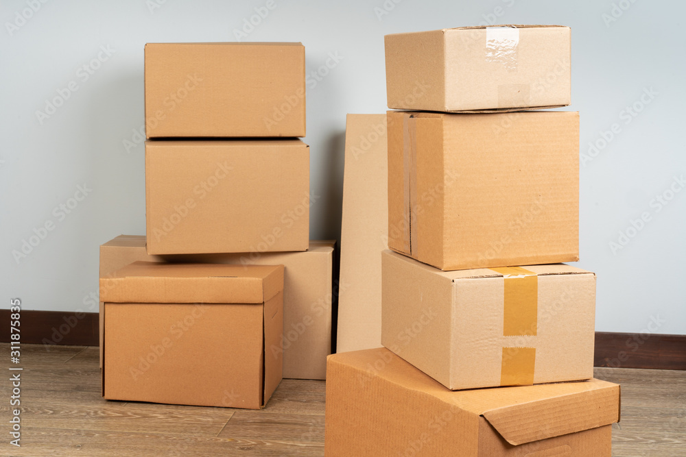 Group of brown carton boxes on wooden floor Group of brown carton boxes on wooden floor