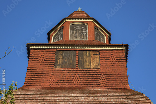 Traditional architecture of old Swedish building in Skansen open air museum at Djurgarden island, historic recreational area. XVIII century wooden Seglora church. Stockholm, Sweden. photo