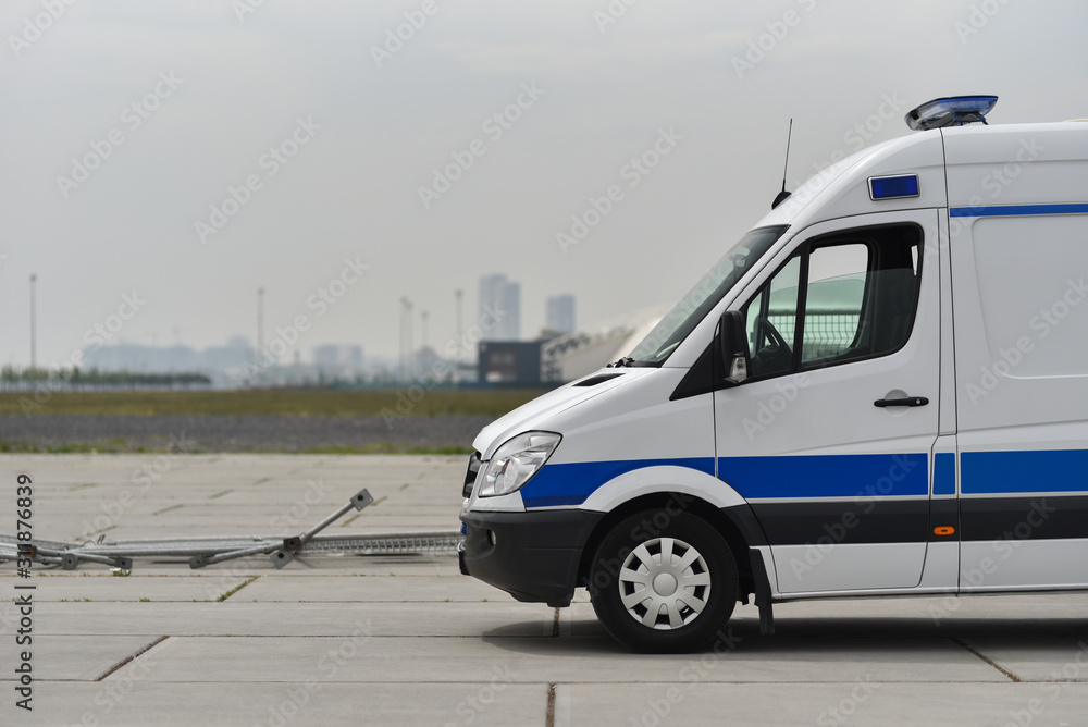 police van on the background of a destroyed metal fence
