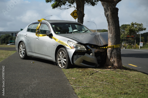 Fotografie Silver sedan car crashed into a tree, Auckland, New Zealand.