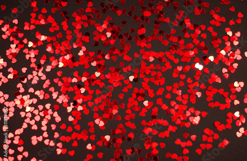 Valentine's day red hearts glitter on black background, holyday background