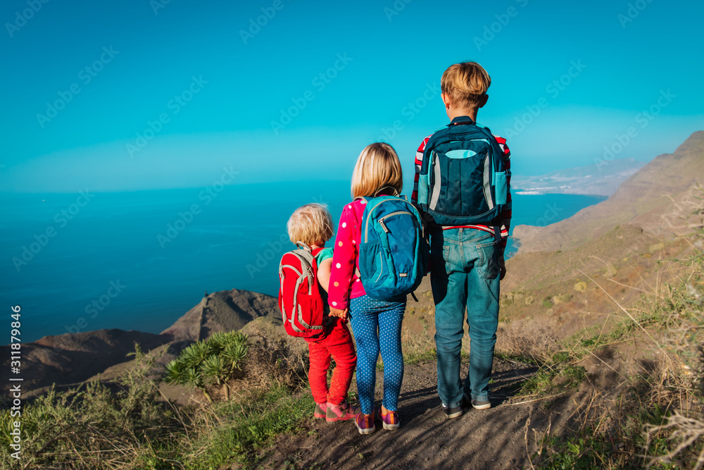 kids-boy and girls- travel in mountains near sea, family in Canary islands, Spain