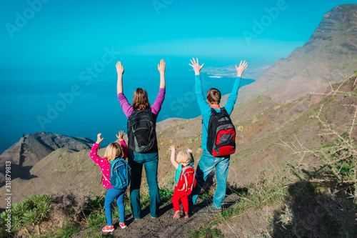 mom, dad with kids travel in mountains near sea, family in Canary islands, Spain