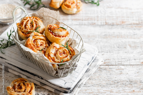 Unsweetened snails and puff pastry with bacon, sesame seeds and rosemary.