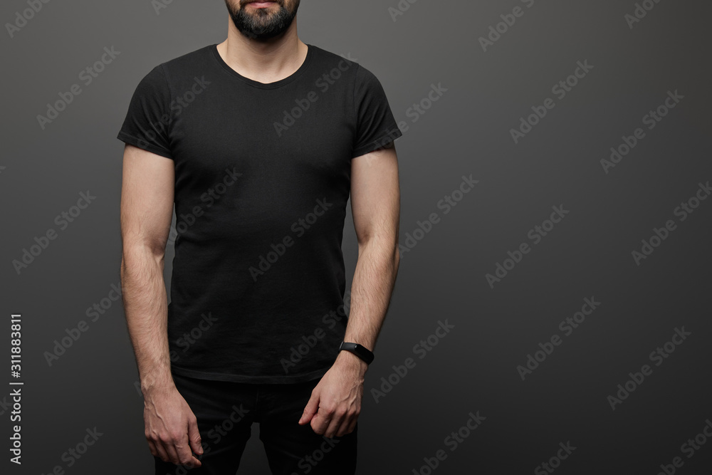 cropped view of bearded man in blank basic black t-shirt on black background cropped view of bearded man in blank basic black t-shirt on black background