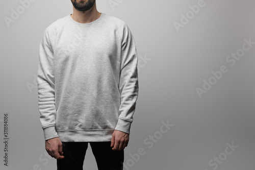 cropped view of bearded man in blank basic grey sweatshirt isolated on grey