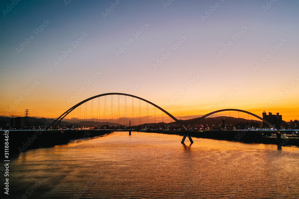 Crescent Bridge - landmark of New Taipei, Taiwan with beautiful illumination at day, aerial photography in New Taipei, Taiwan. Crescent Bridge - landmark of New Taipei, Taiwan with beautiful illumination at day, aerial photography in New Taipei, Taiwan.