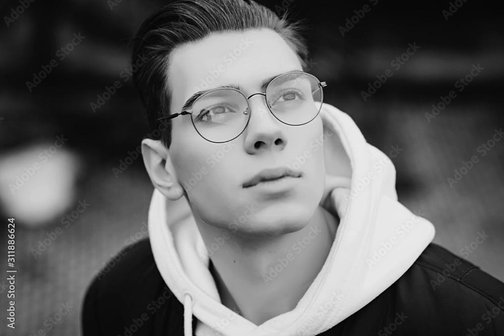 close-up of a handsome man with glasses. black and white photo close-up of a handsome man with glasses. black and white photo