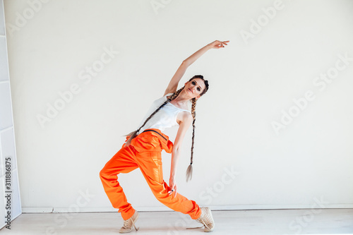 Fototapeta Naklejka Na Ścianę i Meble -  beautiful fashionable dancer dances to music portrait