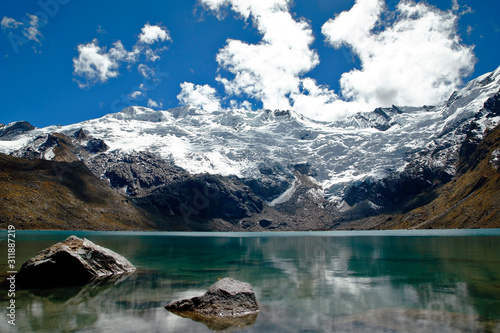 Beautiful cochagrande lagoon at the foot of the snowcapped cochas in the Huaytapallana mountain range. photo