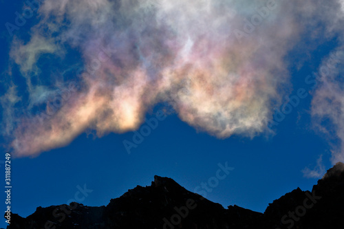 A natural phenomenon called iridescent clouds, in this case recorded in the morning with the light of the sun emerging from the rocks in the high Andean mountains. © Jonathan Chancasana