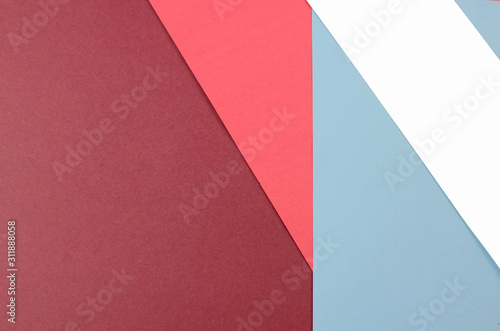 Layers of colored  rough textured construction paper creating a graphic template. Abstract design geometric style color blocks. Copyspace. Coral and blue colors.