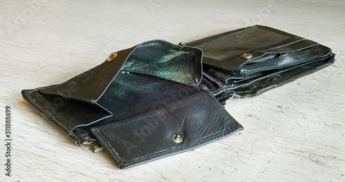 empty wallet or purse, symbol for poverty, destitution, smashup or  tax burden photo