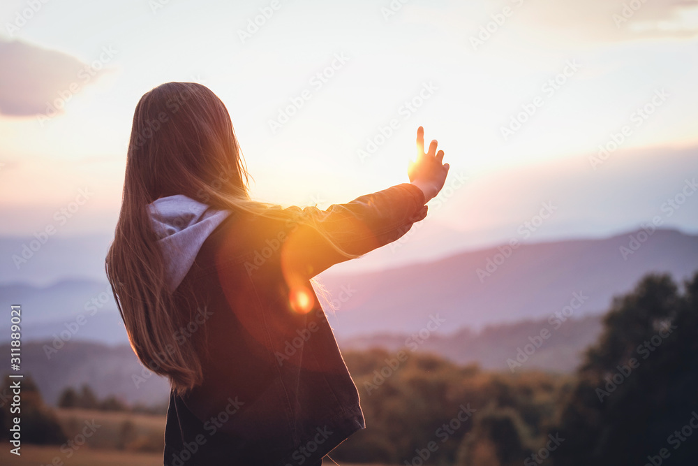 Young Prety Girl Outstretched Arm Covers the Sun Young Prety Girl Outstretched Arm Covers the Sun