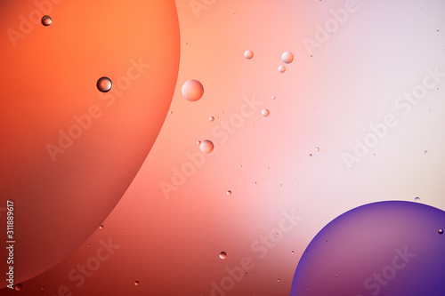 abstract background from mixed water and oil bubbles in red and purple color