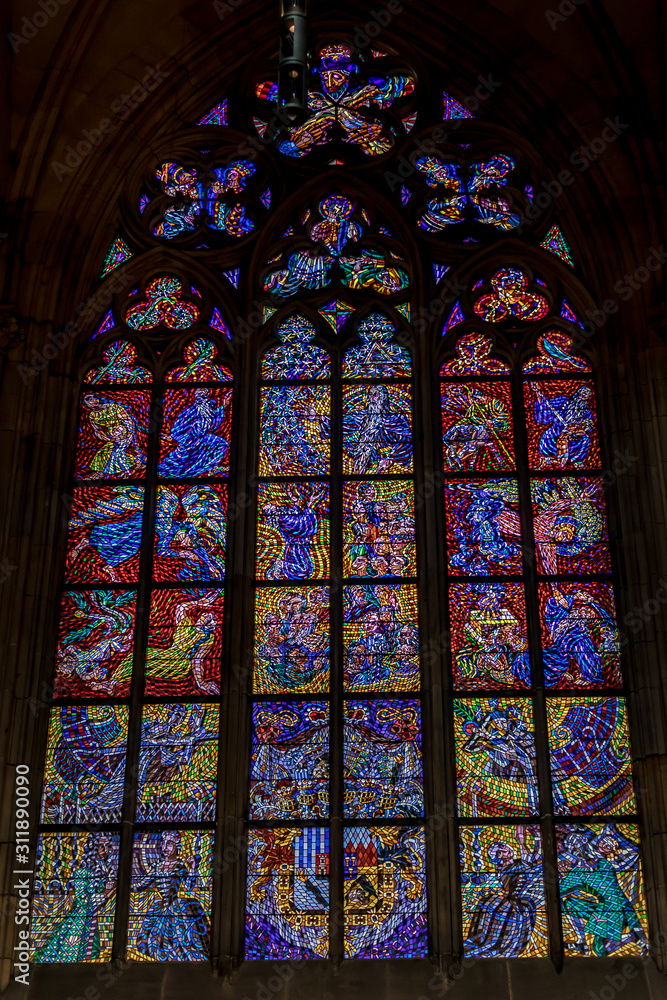 Prague, Czech Republic: Colorful religious stained glass window inside St. Vitus Cathedral