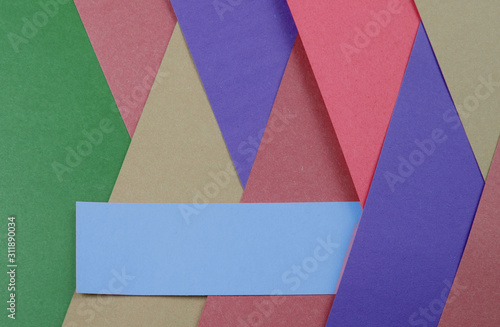 Layers of colored  rough textured construction paper creating a graphic template. Abstract design geometric style color blocks. Copyspace. Rainbow colors.