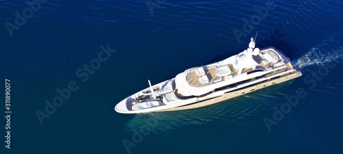 Aerial drone ultra wide photo of luxury mega yacht with wooden deck cruising Aegean deep blue sea © aerial-drone