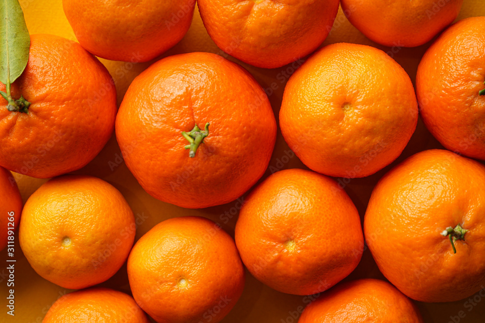 Orange tangerines on a yellow background close-up. Orange tangerines on a yellow background close-up.