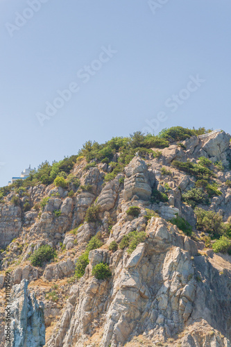 Mountains and rocks on the beach in summer on a Sunny day