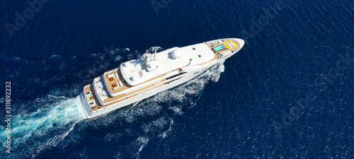 Aerial drone ultra wide photo of small yacht cruising deep blue open ocean sea © aerial-drone