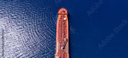 Aerial drone ultra wide photo of industrial petrochemical oil and gas fuel tanker ship cruising Mediterranean deep blue sea © aerial-drone