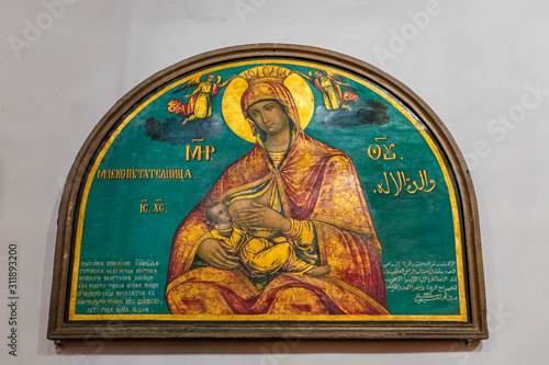Icon of the Mother of God of a nursing baby hanging on the wall in the hall of the St. Nicholas church in Bay Jala - a suburb of Bethlehem in Palestine