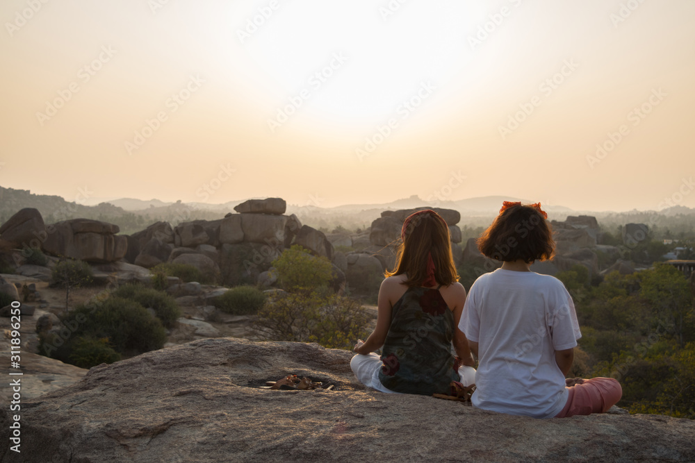 Two woman doing meditation in Hampi, Karnataka, India Two woman doing meditation in Hampi, Karnataka, India