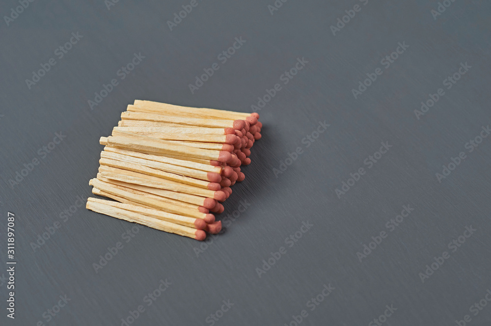 Heap of many matches with red sulfur on dark concrete desk on kitchen. Space for text Heap of many matches with red sulfur on dark concrete desk on kitchen. Space for text