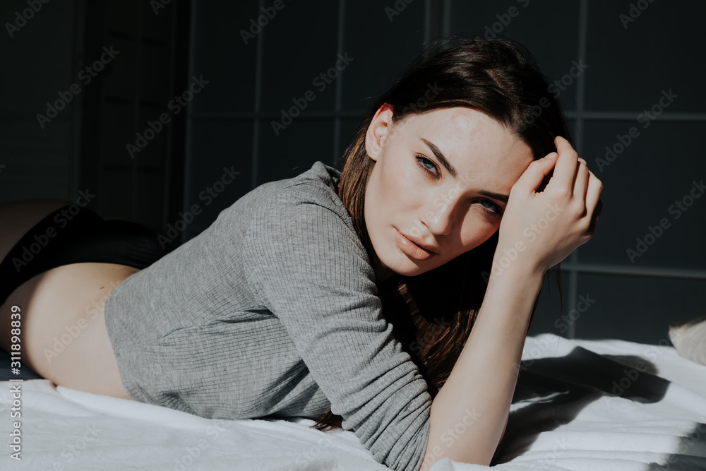 beautiful woman in underwear lies on the bed in the bedroom beautiful woman in underwear lies on the bed in the bedroom