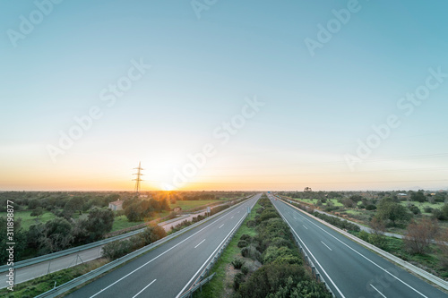Spectacular panoramic views of a motorway in Majorca crossing a rural environment, called Autopista de Levante in Spanish, with an impressive sunset © Miguel